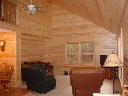 Livingroom at Wilderness Pines in Gaylord Michigan features knotty pine interior and log furniture.