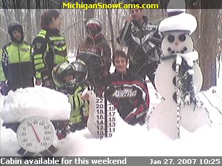 Gordon, Stephanie, Bradley, Justin, Marie, Trenton and Randy standing knee deep in snow next to the Snowman.